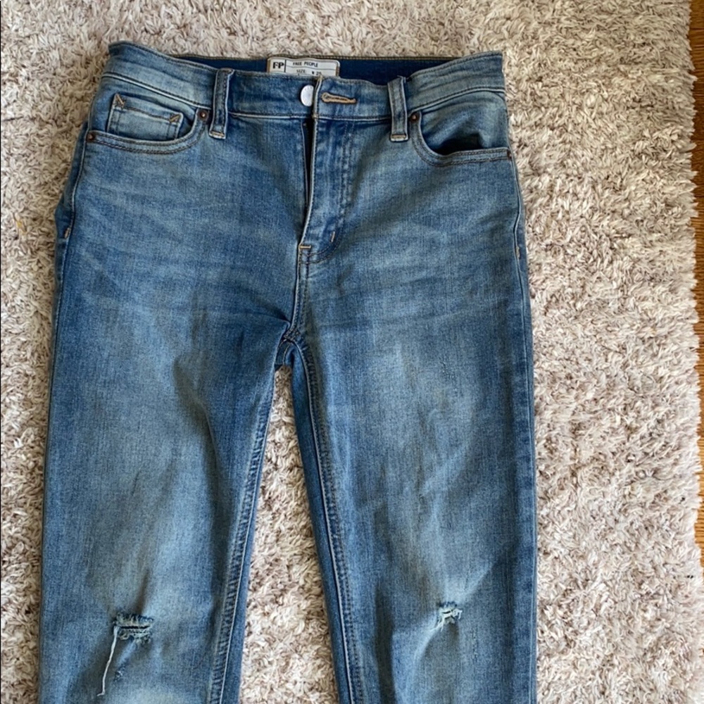 Light wash free people jeans. Frayed at the end